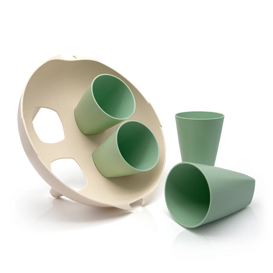 A set of four cups with a cup holder made from waste sugarcane